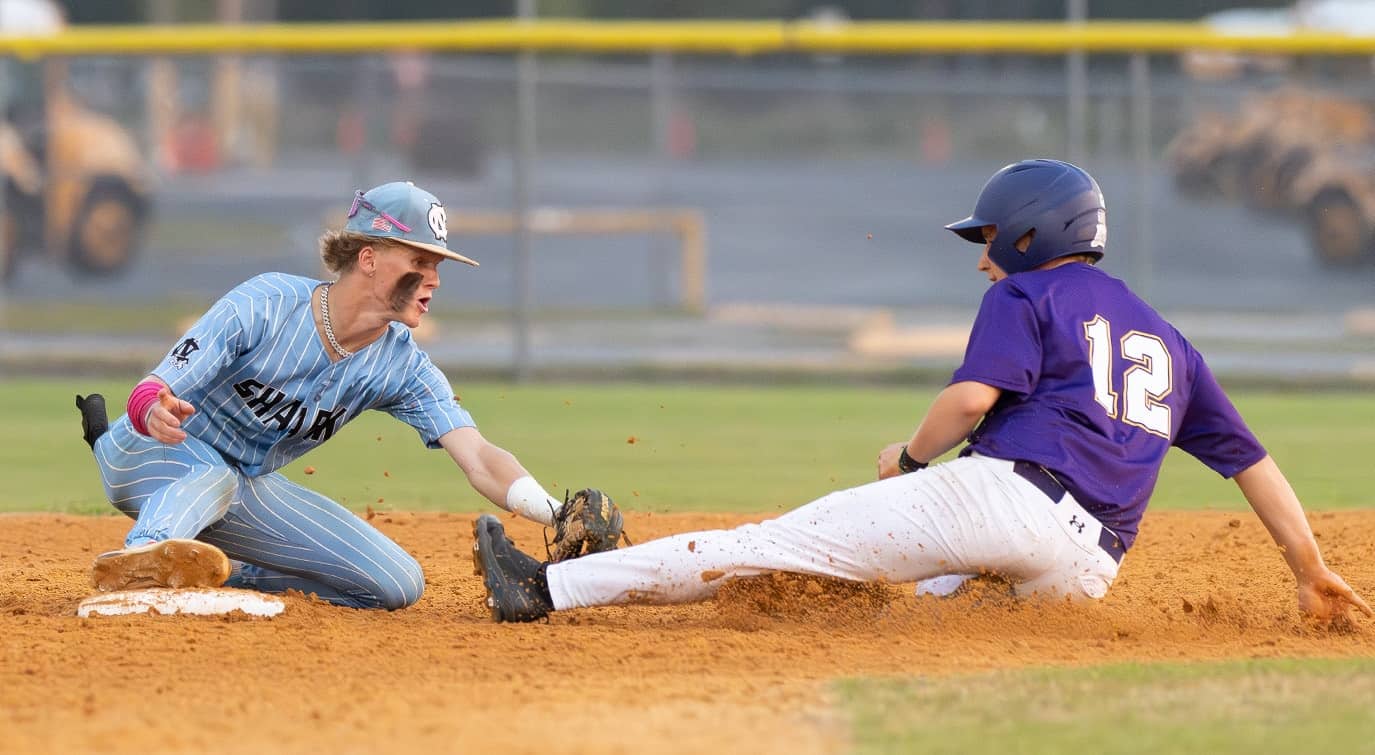 Nature Coast Tech shortstop, Cody Wright tags Hernando High’s ,12, Bryce Salesman to complete a double play in the 4A District 6 title game. Photo by [Joseph Dicristofalo]