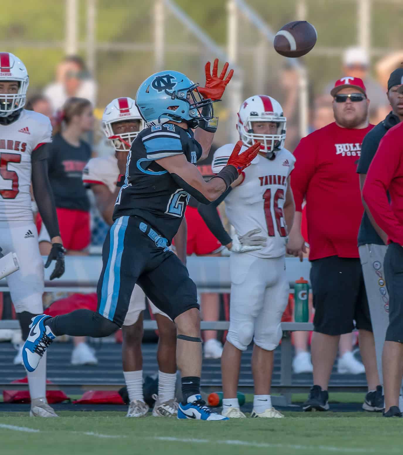 Nature Coast Tech, 24, Cashis Williams looks in a pass in the game with visiting Tavares High Friday in Brooksville. Photo by [Joseph DiCristofalo]