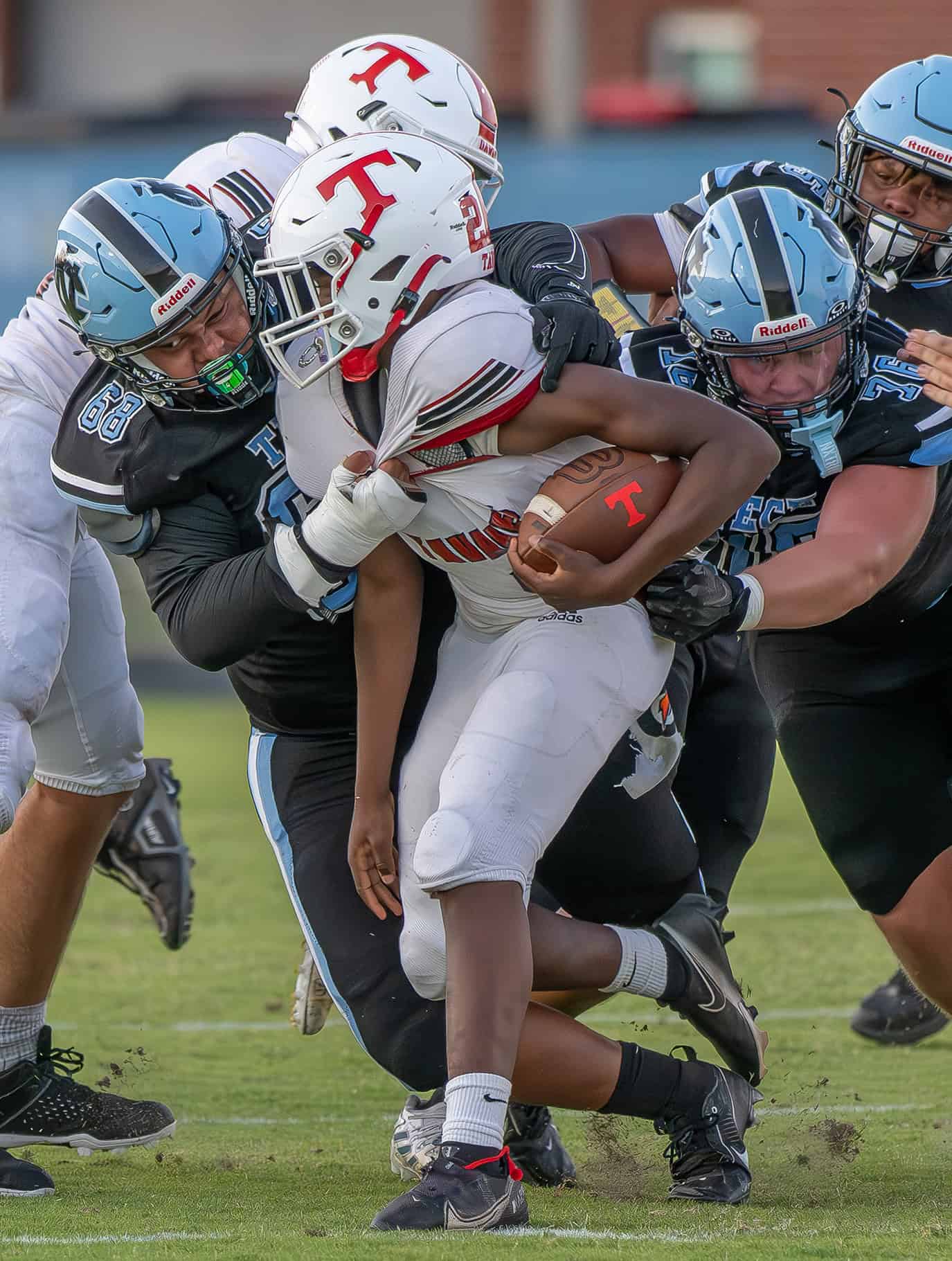 Nature Coast Tech, 68, Ben Harper, wraps up a Tavares High runner Friday in Brooksville. Photo by [Joseph DiCristofalo]
