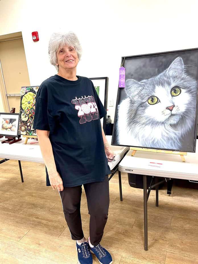 Sandy Philips with her portrait 