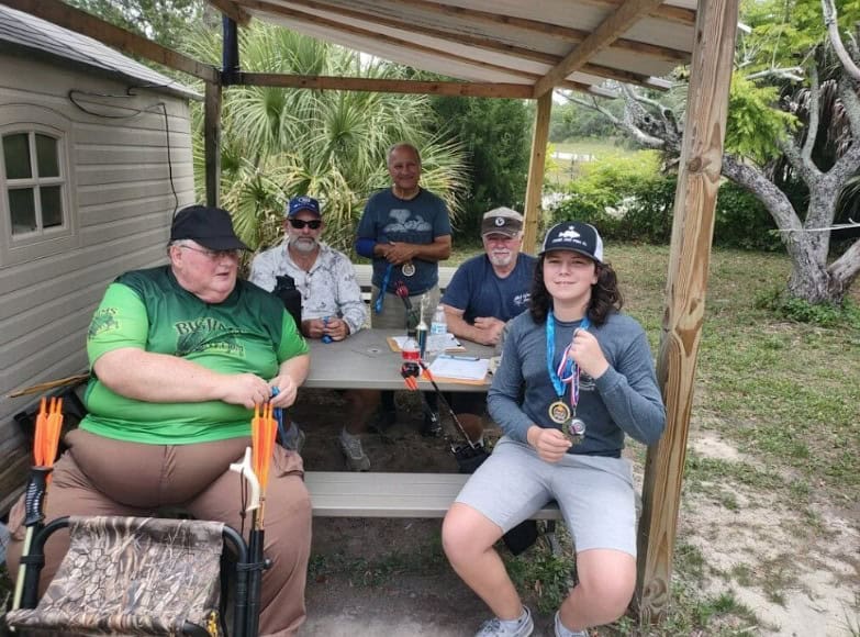 Club President David Ireland (center) with fellow archery club members and FAA State Sectional competitors. [Photos by competitors' parents provided by David Ireland]