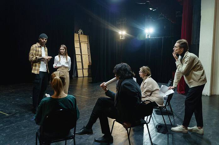 Acting troupe gathering on stage