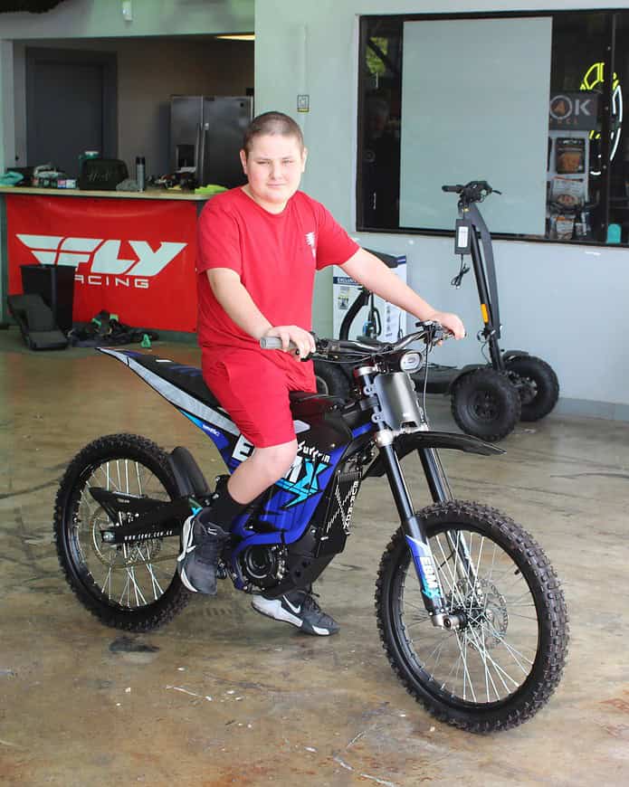 Deegan Giglio sits atop his new Surron electric motorbike on Friday. [Photo by Austyn Szempruch]
