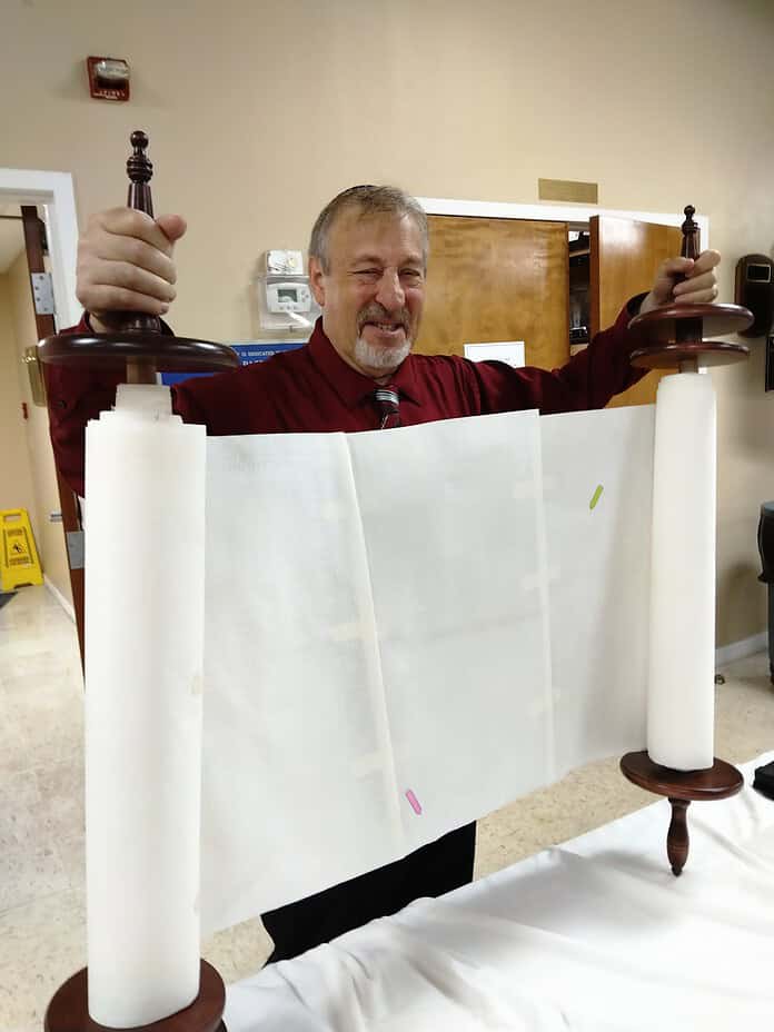 Rabbi Lenny Sarko shows the Braille Torah to members of Temple Beth David. [Courtesy photo]