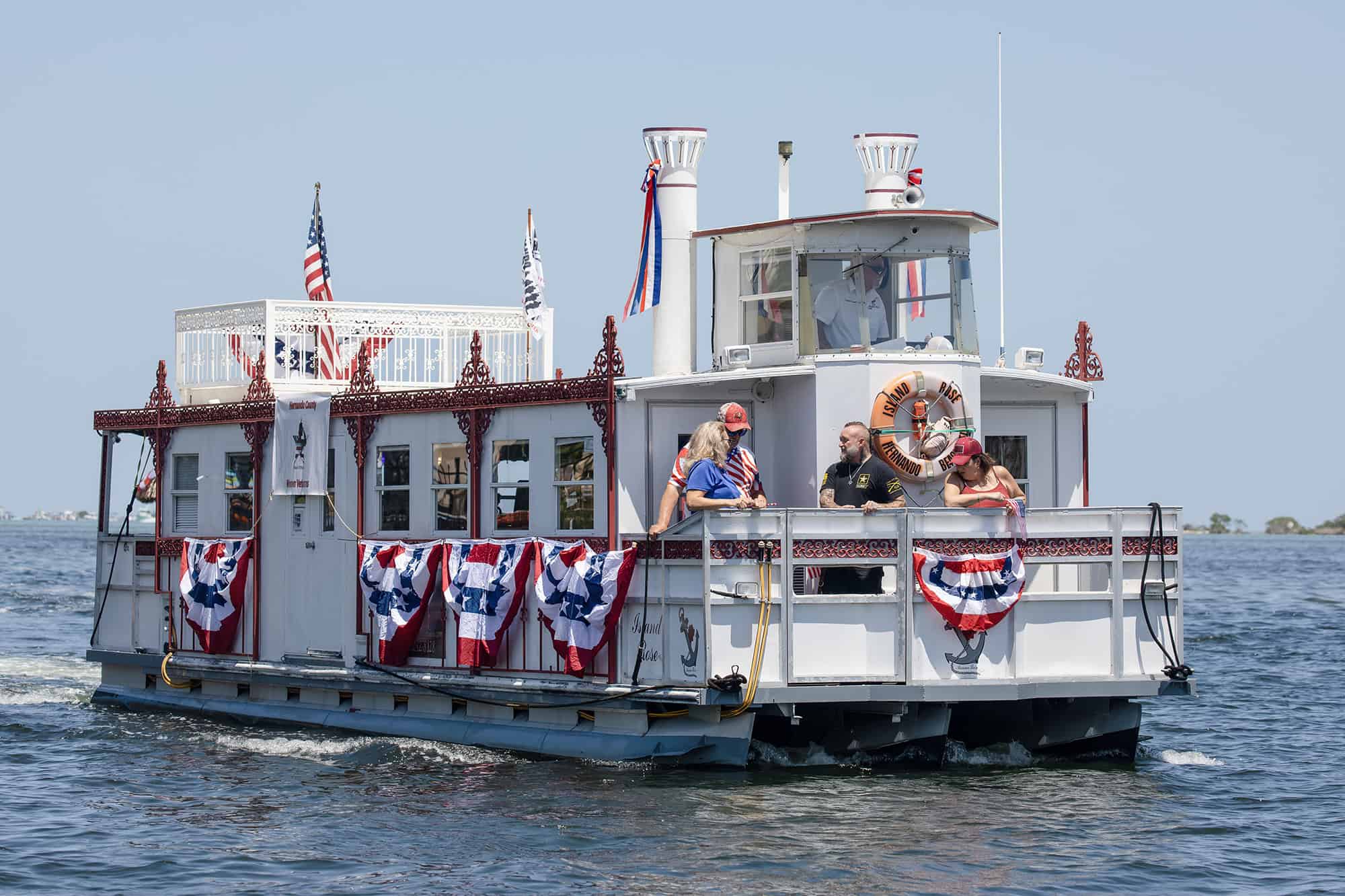 Leading the parade was the Island Rose, provided by Marina Rose Enterprises carrying the Grand Marshall Neal Bowling and his support dog.  Also onboard were David Williams and the Hernando County Women Veterans group, founded by Jean Ware, USAF.

[Photo by Frank Harder]