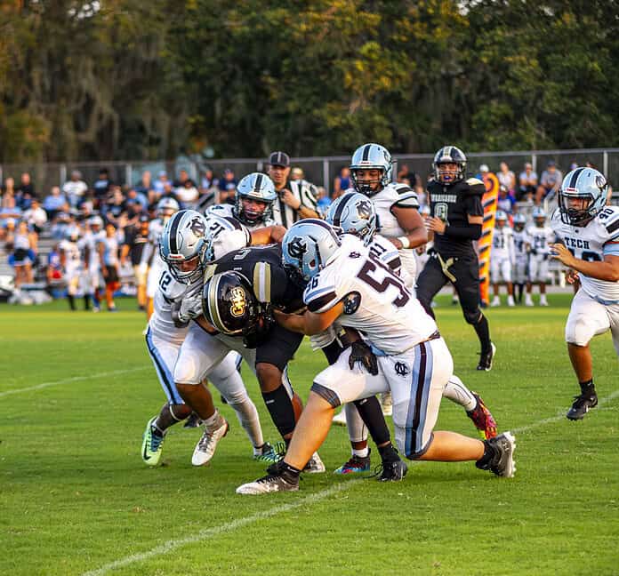 NCT's Joseph Lizor, Gianni Labdar, and Zaihron Mccullough tackle Citrus player. [Photo by Hanna Maglio]