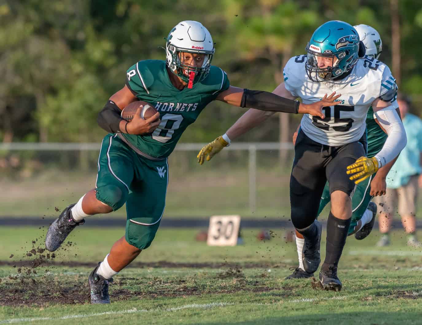 Weeki Wachee High's ,8, Leelan Wright uses a stiff arm to avoid a Sunlake tackler Friday night in Brooksville. [Photo by JOE DiCRISTOFALO]