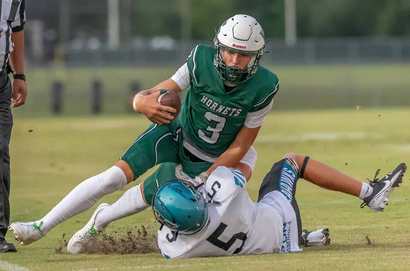 Weeki Wachee QB, 3, Richard Hanshaw gets pulled down near the sideline after a gain versus Sunlake. [Photo by JOE DiCRISTOFALO]