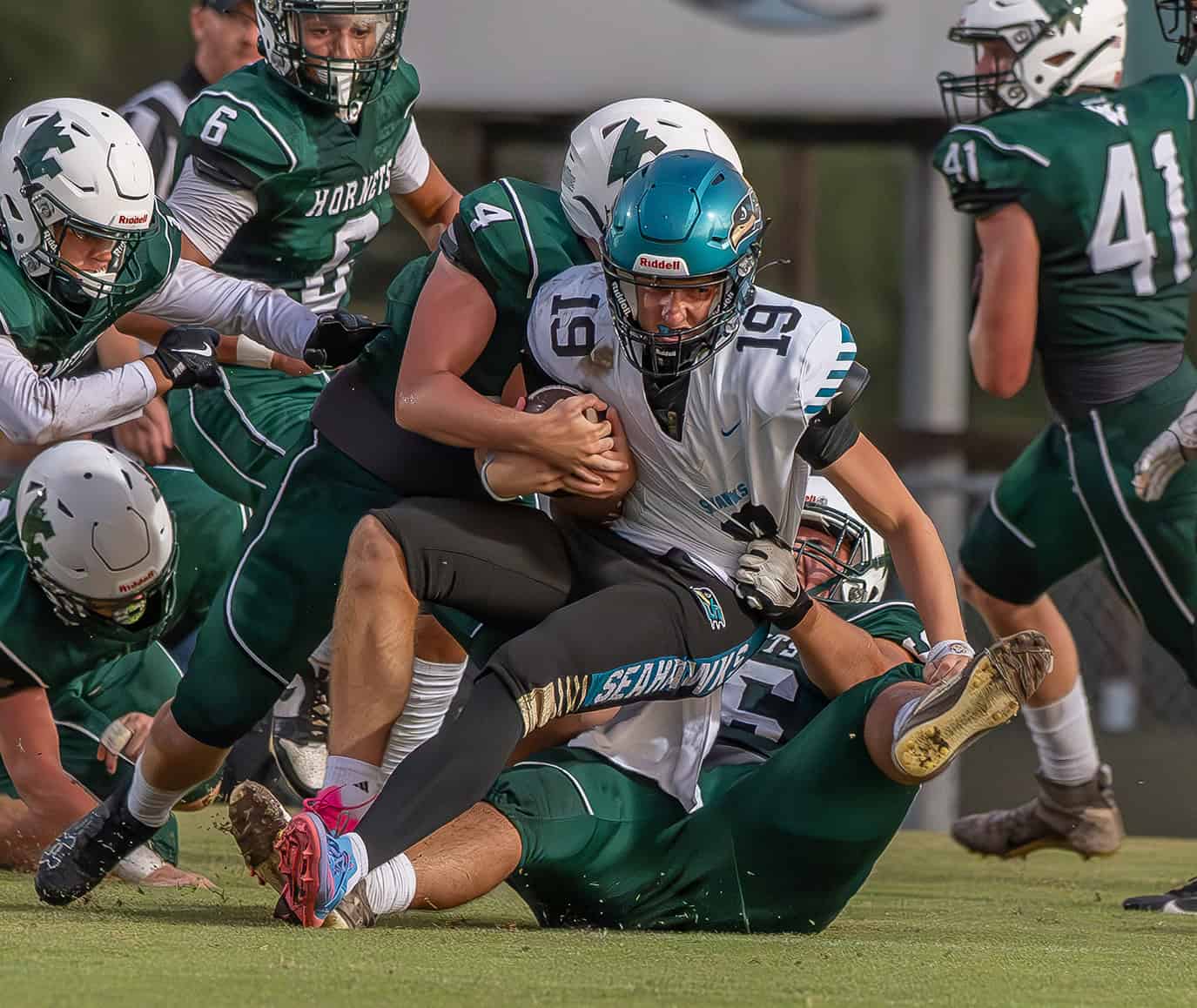 Weeki Wachee , 4, Jas Salatino and ,56, Radniel Cedeno team up to sack Sunlake QB, 19, Hayes Mcquire Friday at Weeki Wachee. [Photo by JOE DiCRISTOFALO]