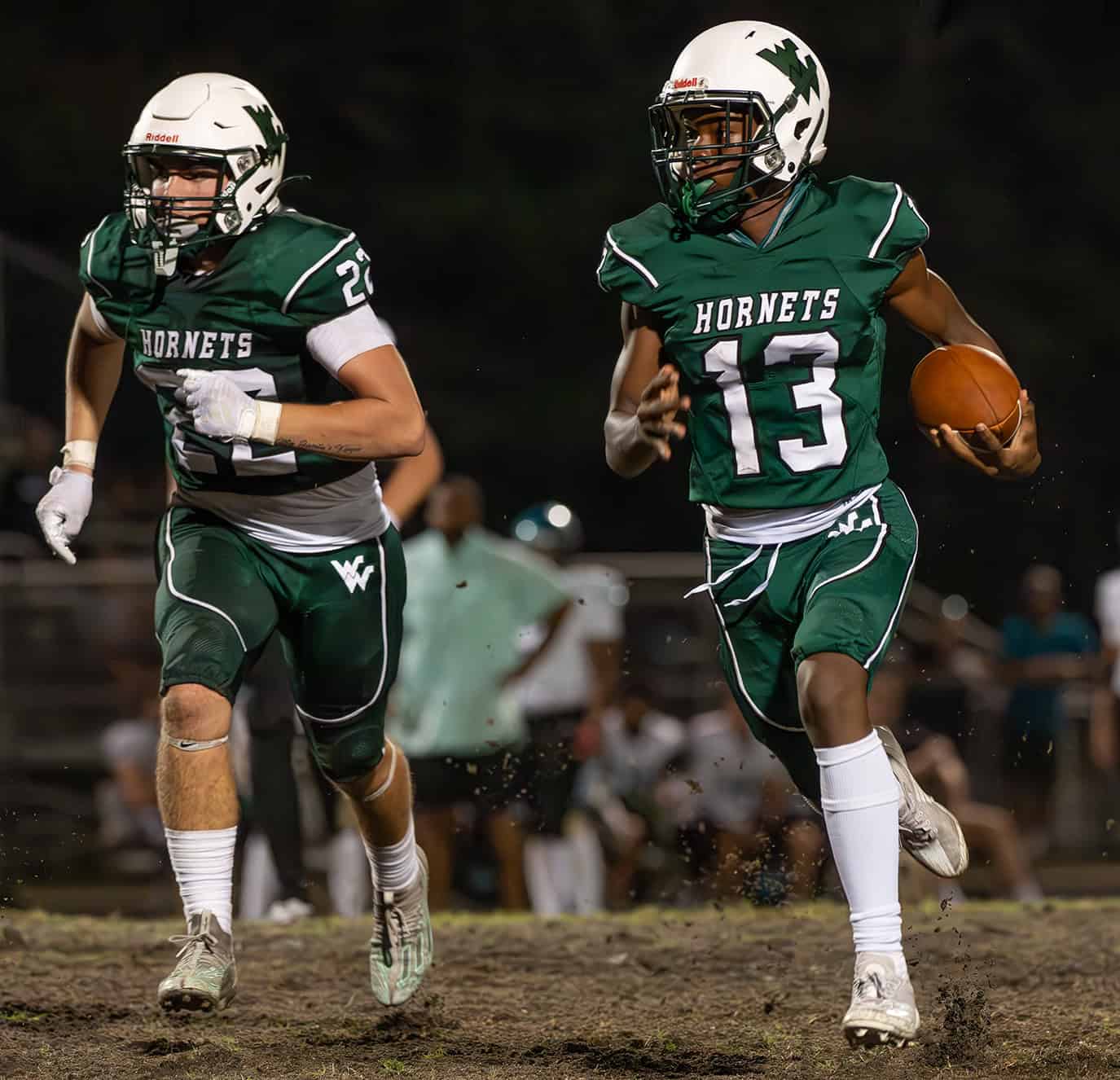 Weeki Wachee , 13, Keavin Moss follows teammate, 22, Zachary Wolfe after an interception during the second half of the home game with Sunlake. [Photo by JOE DiCRISTOFALO]