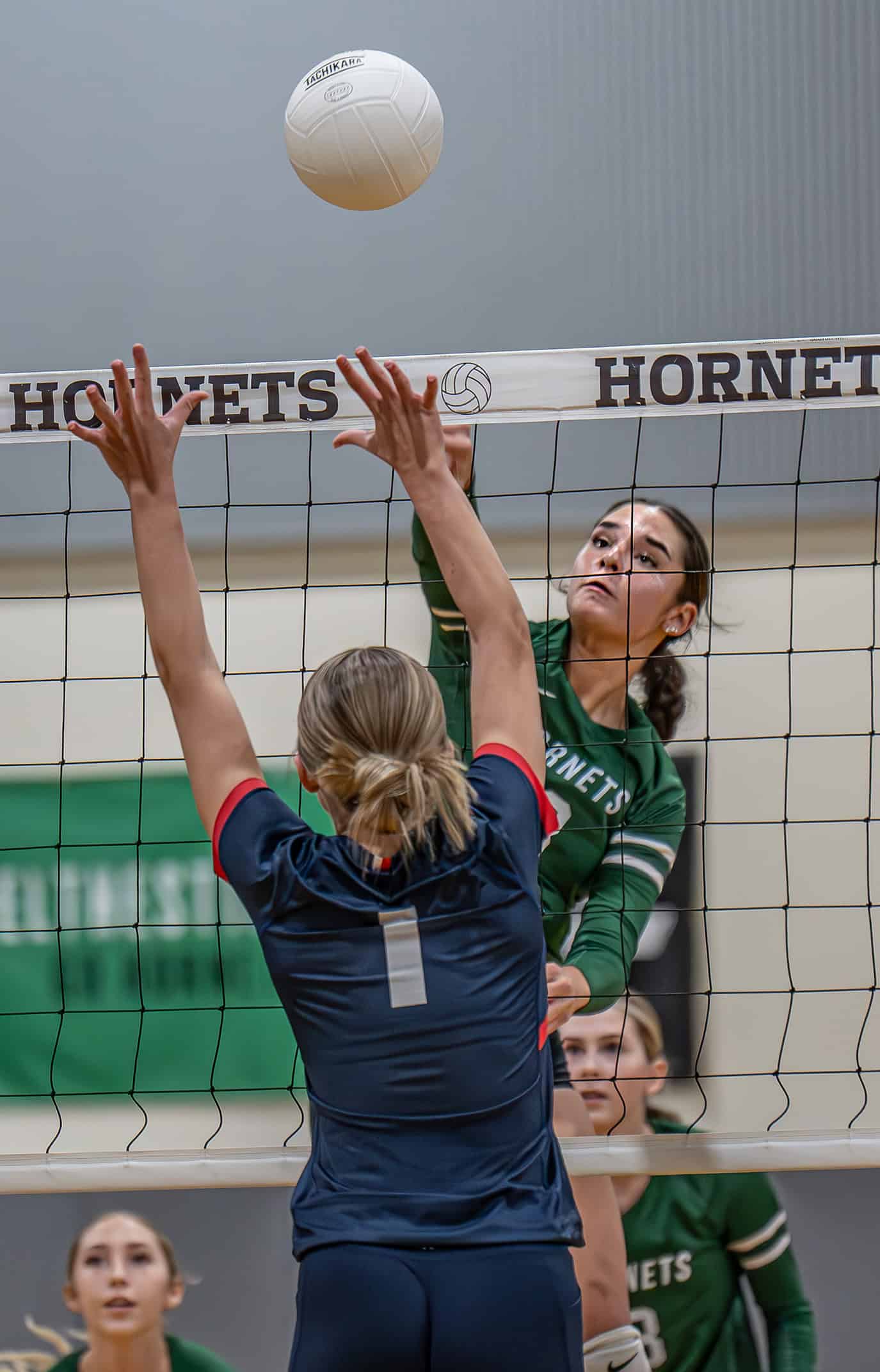 Weeki Wachee High, Marlee Schumacher hits over the defense of Springstead High's Rylynn Lanziero, 1, Tuesday at Weeki Wachee High. [Photo by JOE DiCRISTOFALO]