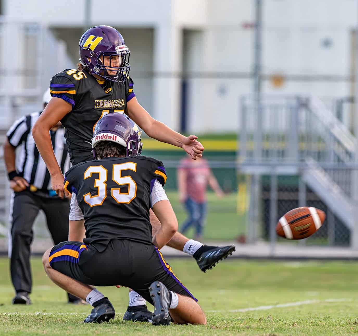 Hernando High kicker, 45,Ernest Gay kicks out of  the hold by ,35, Landon Ball for a extra point in the 54-6 win over Hollins High School Friday in Brooksville. [Photo by Joe DiCristofalo]