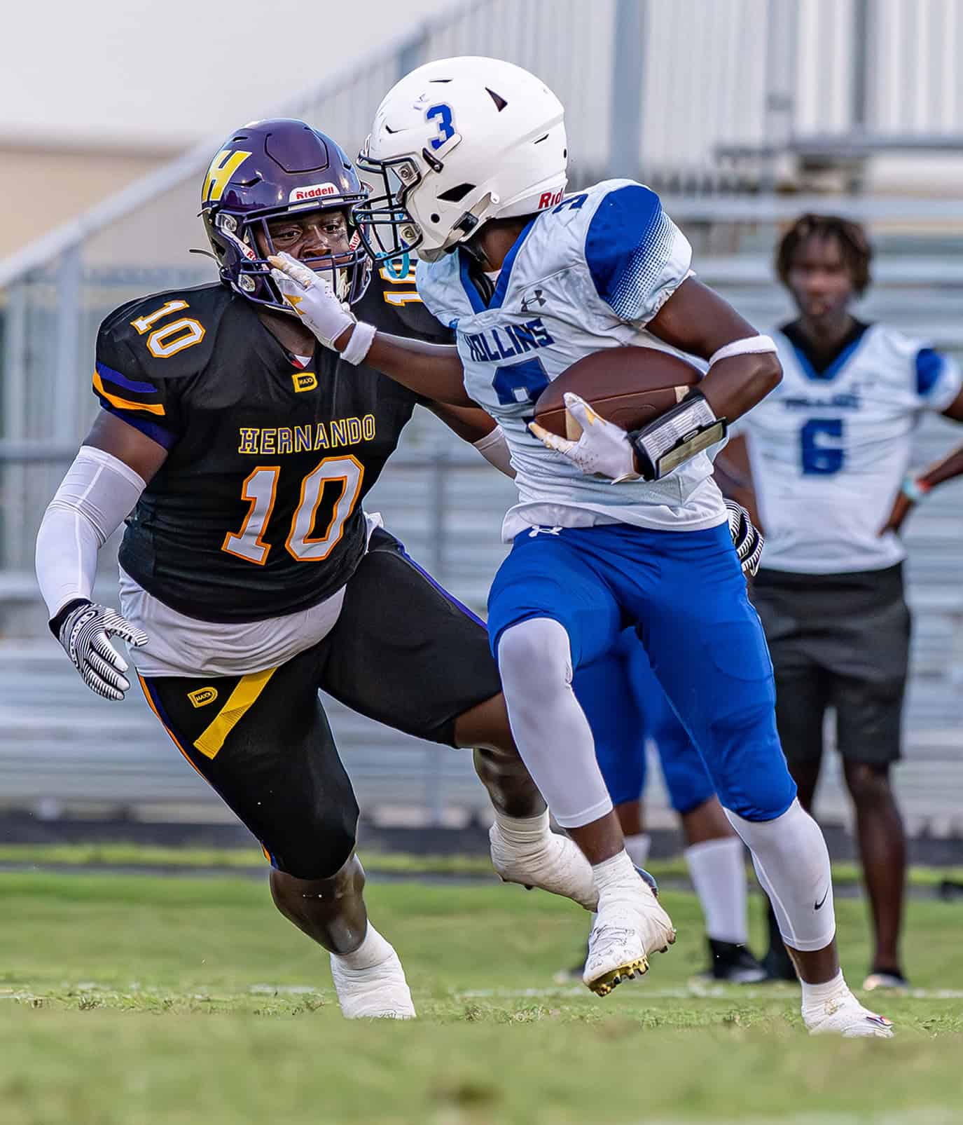 Hernando High running back, 10,  Keaundre Gavin  fought through a stiff arm to tackle Hollins High School , 3, Jamal Gordon for a loss Friday in Brooksville. [Photo by Joe DiCristofalo]