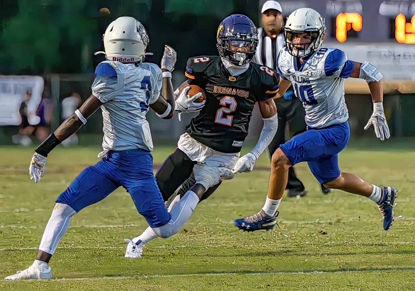 Hernando High running back, 2, Gabe Sansone cuts back to elude Hollins High School defender, 3, Jamal Gordon Friday in Brooksville. [Photo by Joe DiCristofalo]