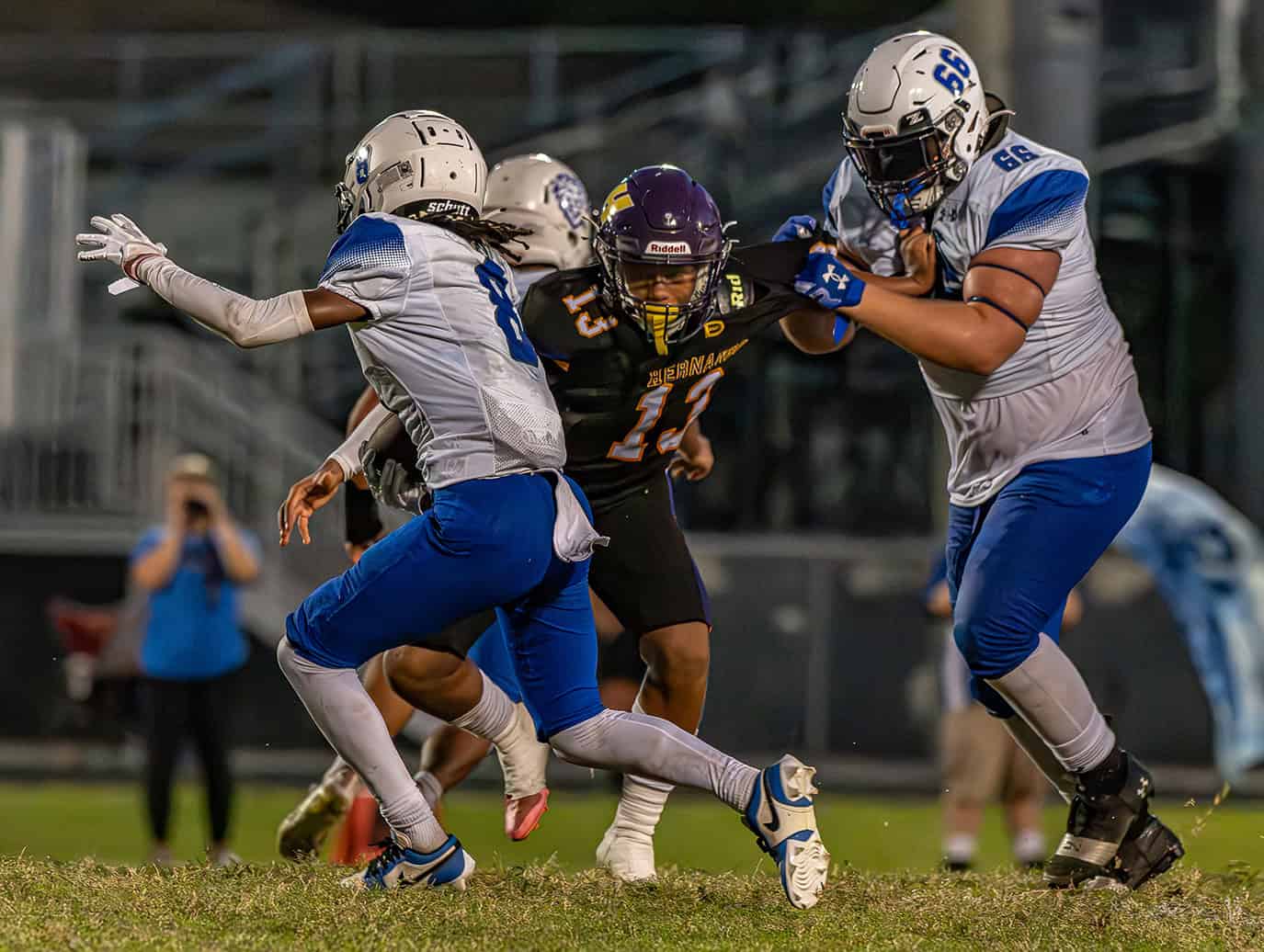 Hernando High , 13,  Jason Ingram gets held while attempting to tackle Hollins High School ,8, Juelz Smith-Clark Friday in Brooksville. [Photo by Joe DiCristofalo]