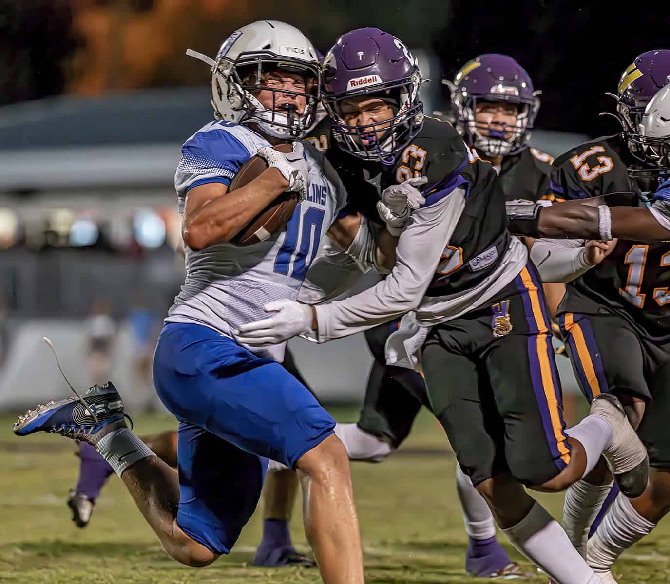 Hernando High , 23, Michael Brown  abruptly stops the progress of Hollins High School ,10, Joel Diaz- Rosario Friday in Brooksville. [Photo by Joe DiCristofalo]