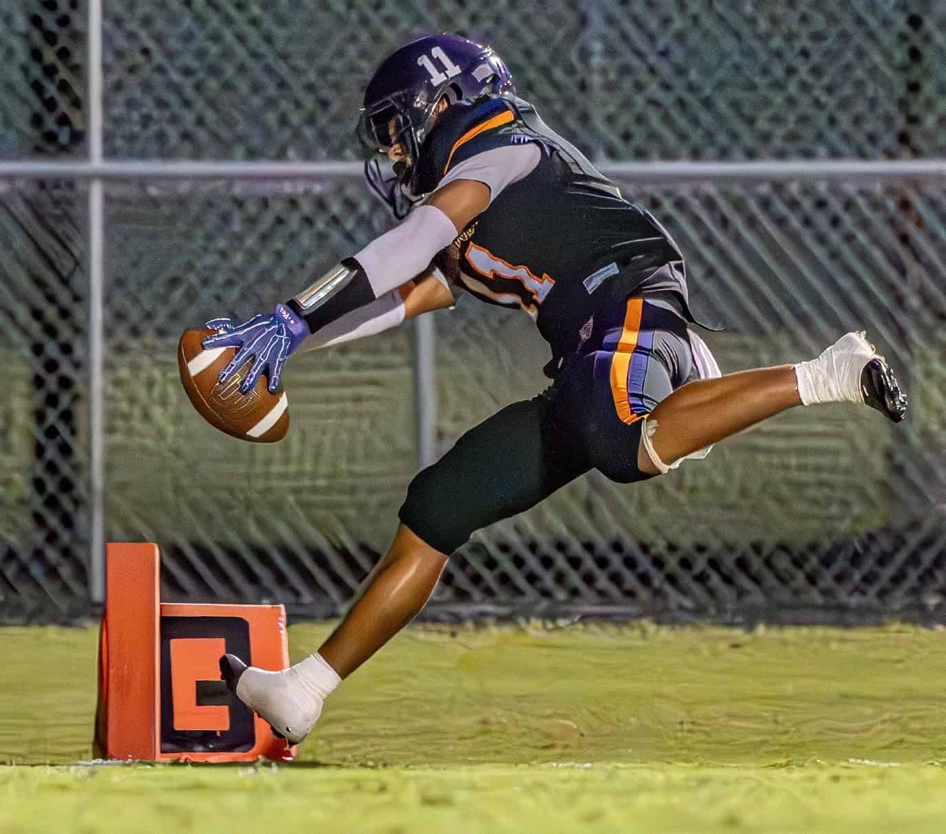 Hernando High running back, 11,  Kamona Dotson stretches for the pylon and an apparent score but was ruled out of bounds at the four yard line, the Leoprds scored two plays later against Hollins High School Friday in Brooksville. [Photo by Joe DiCristofalo]