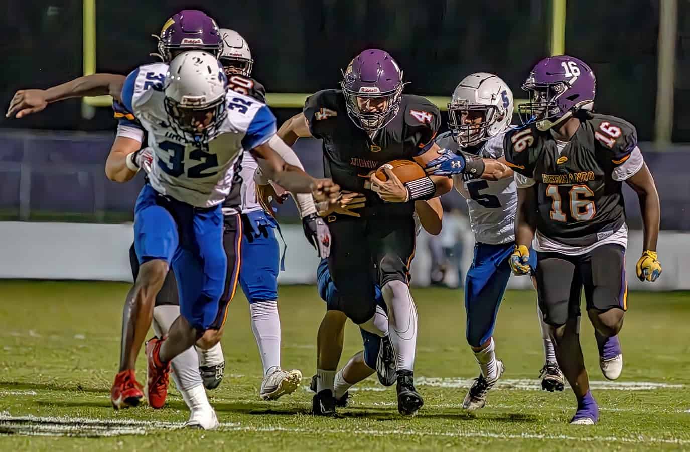 Hernando High quarter back, 4, Michael Saltsman takes a keeper play  for a first down against visiiting Hollins High School Friday in Brooksville. [Photo by Joe DiCristofalo]