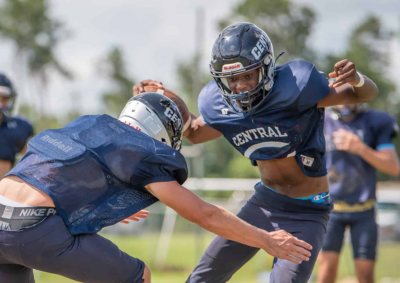 Central High's Sam Jackson tries to elude a tackle by Troy Broadwater during practice on Monday. [Photo by Joe DiCristofalo]