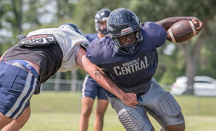 Central High's Amon Grimes avoids a tackle attempt by Koby Zwaan during practice. [Photo by Joe DiCristofalo]