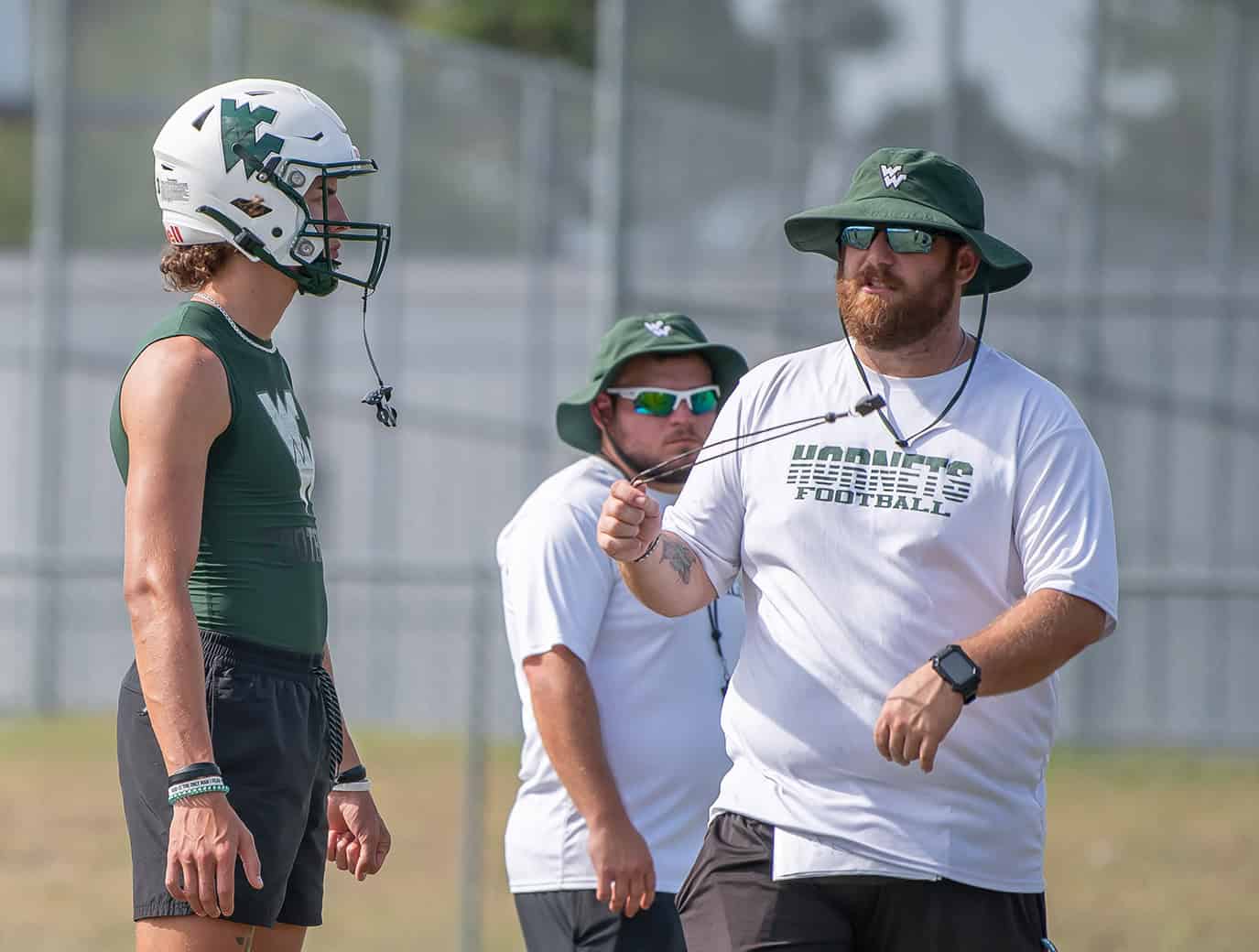 Weeki Wachee QB, Richard Hanshaw gets some pointers from Head Coach Justin Bland Monday at practice.[Photo by Joe DiCristofalo]]