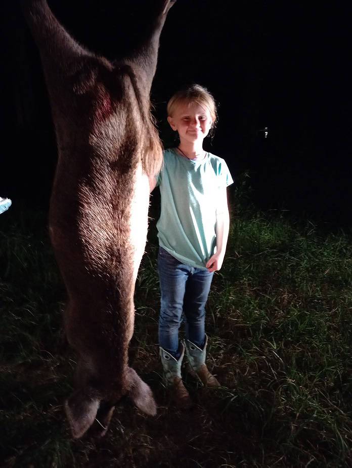 Bristol Cummins and her very first hog, after a trapping adventure with her daddy Sean and Ol' Uncle Toby in Istachatta. [Photo by Toby Benoit]