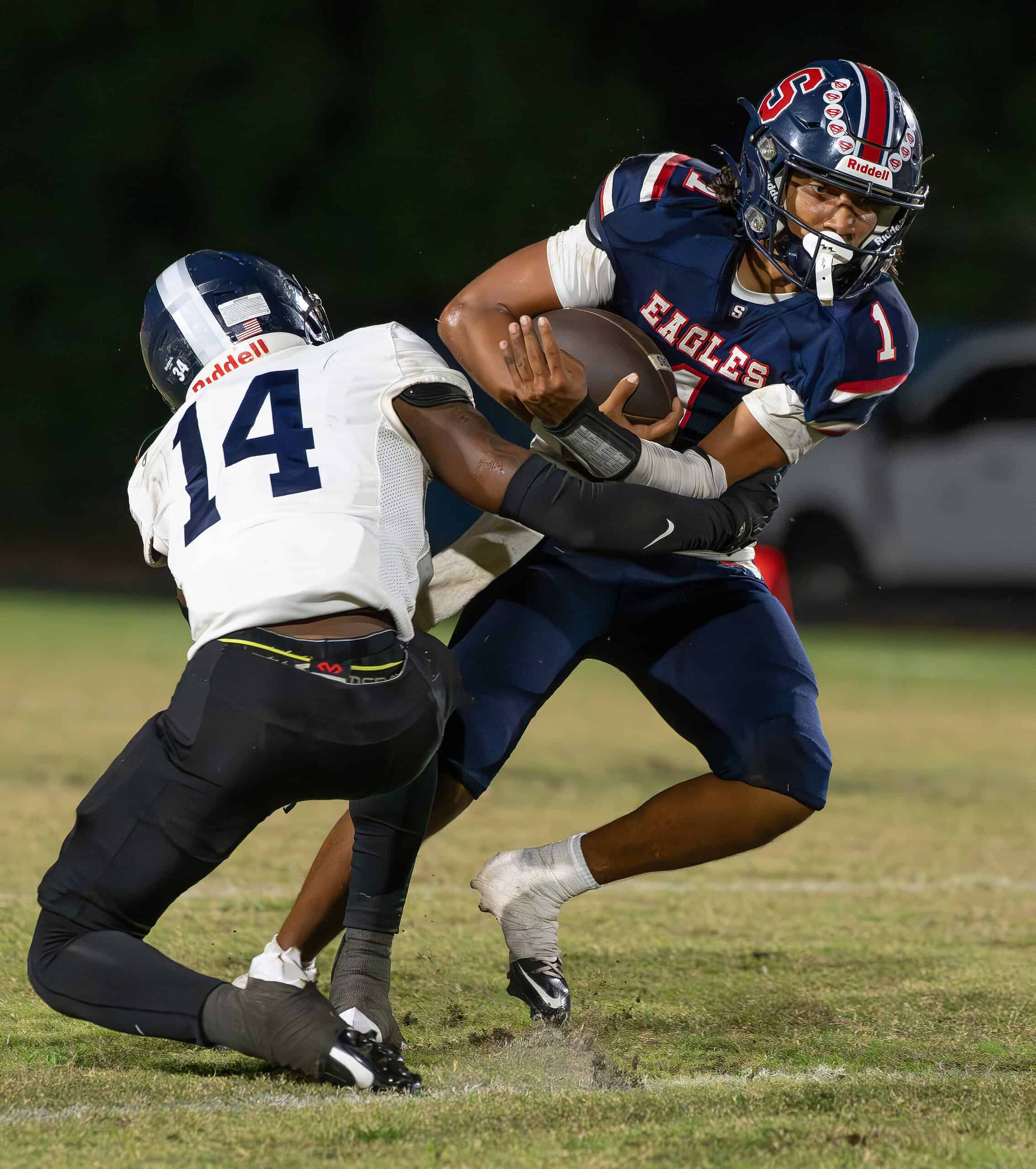 Springstead High, 1, Gio Martinez attempts to break free from Gaither High ,14, John Benson Thursday at Booster Stadium. [Photo by Joe DiCristofalo]
