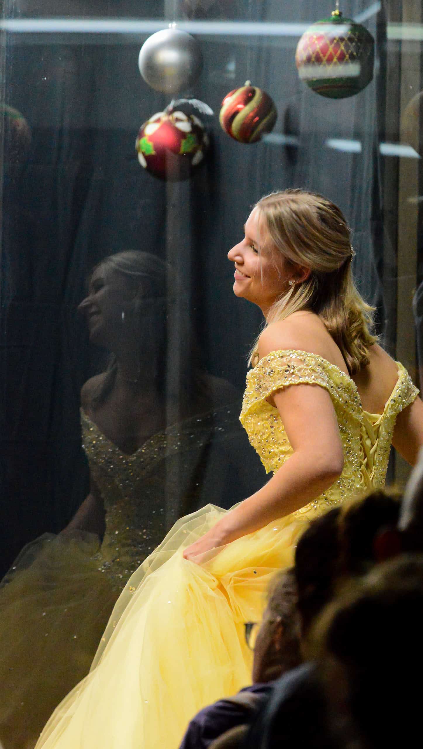 A model reacts to the audience of “Windows Come Alive” at Patricia’s Boutique during the Brooksville Tree Lighting on December 5, 2024. [Photo by Jenifer Truitt]
