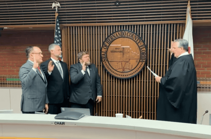 Amsler takes the oath of office alongside John Allocco and Steve Champion on Nov. 19. From left to right: Steve Champion, John Allocco, Ryan Amsler and Judge Hitzemann. [Credit: Hernando County Government]