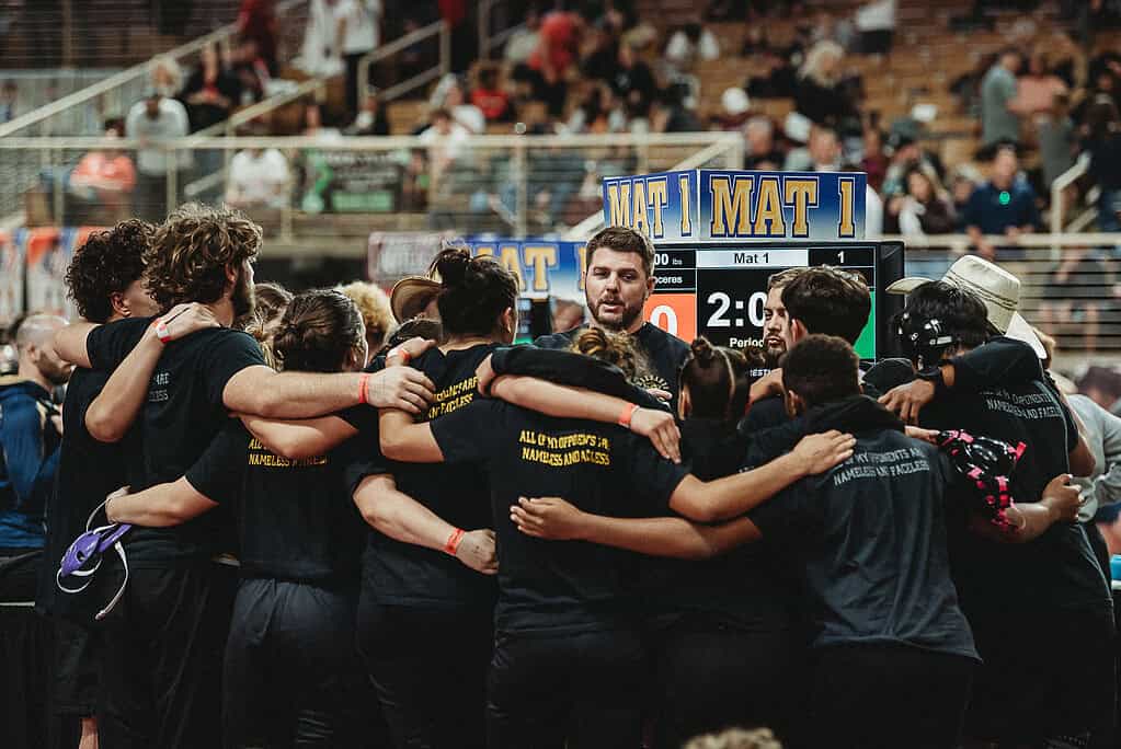 Hernando High School Wrestlers huddle with Head Coach David Pritz before the 2025 FHSAA State Wrestling Championships at Silver Spurs Arena in Kissimmee. [Photo by Cynthia Leota]