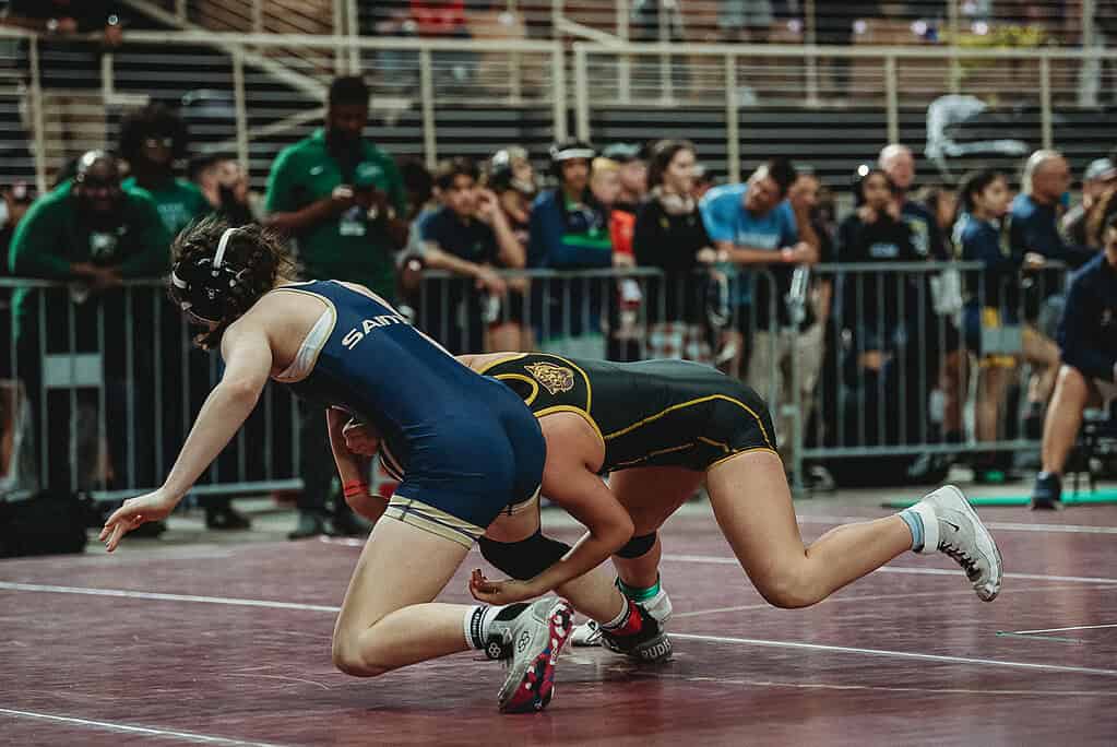 Daniela Espinal (SR) of Hernando gets the takedown against Sara Goodman of Sandlewood in a 125-pound match at the 2025 FHSAA State Wrestling Championships at Silver Spurs Arena in Kissimmee. [Photo by Cynthia Leota]