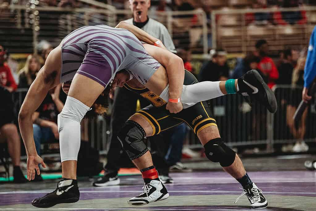 James Shaw Garrett (JR) of Hernando looks to take down Roderick Schwartz of Booker HS in a 175-pound match at the 2025 FHSAA State Wrestling Championships at Silver Spurs Arena in Kissimmee. [Photo by Cynthia Leota]