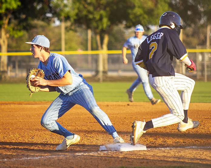 Joe Rozsa, 15, gets the out on Jose Legar, 2, at first base during a game at Nature Coast Technical High School in Brooksville, Fla., on Wednesday, March 19, 2025. (Photo by Hanna Maglio)
