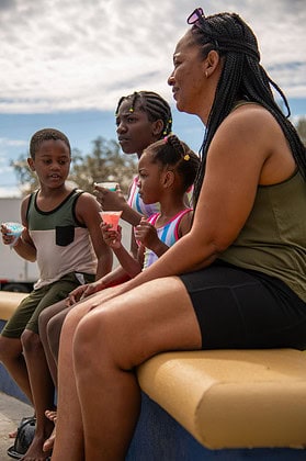 Local school teacher Crisana Smith and her children enjoyed the Tom Varn Park splash pad grand opening on March 1, 2025. [Photo by Jenifer Truitt]