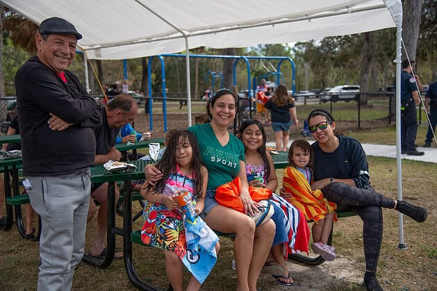 Yeceny Mansfield (right) and her family take a lunch break at the Tom Varn Park splash pad grand opening on March 1, 2025. [Photo by Jenifer Truitt]