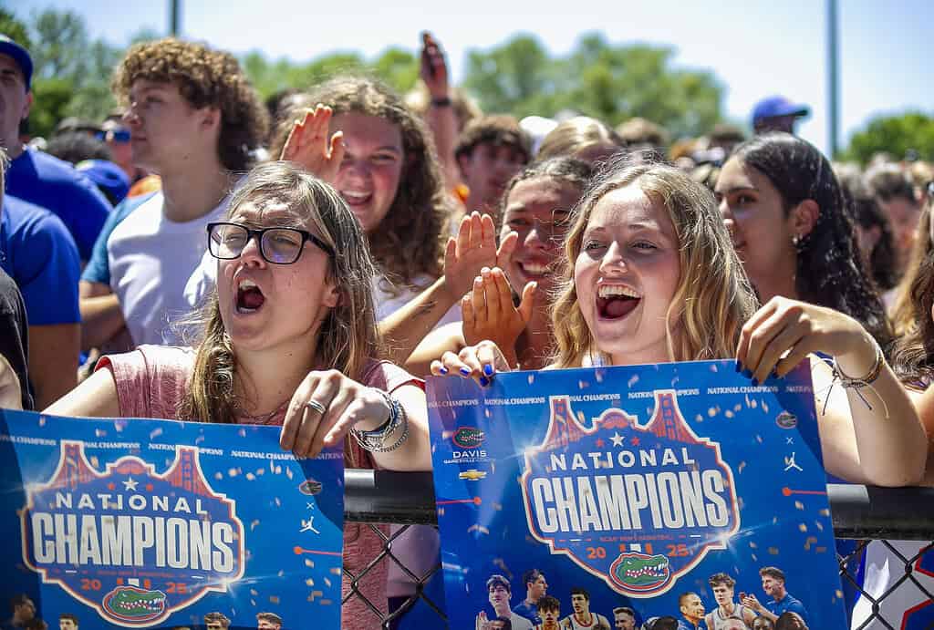 Rachel Hughes (right) and Alyssa Castellano (left) display their posters at the Championship Rally on Flavet Field in Gainesville, Fla., on Tuesday, April 8, 2025. (Photo by Hanna Maglio)