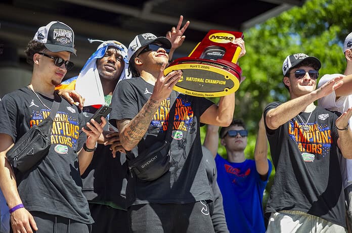 Will Richard thrusts up the NCAA Championship trophy during the Championship Rally on Flavet Field in Gainesville, Fla., on Tuesday, April 8, 2025. (Photo by Hanna Maglio)