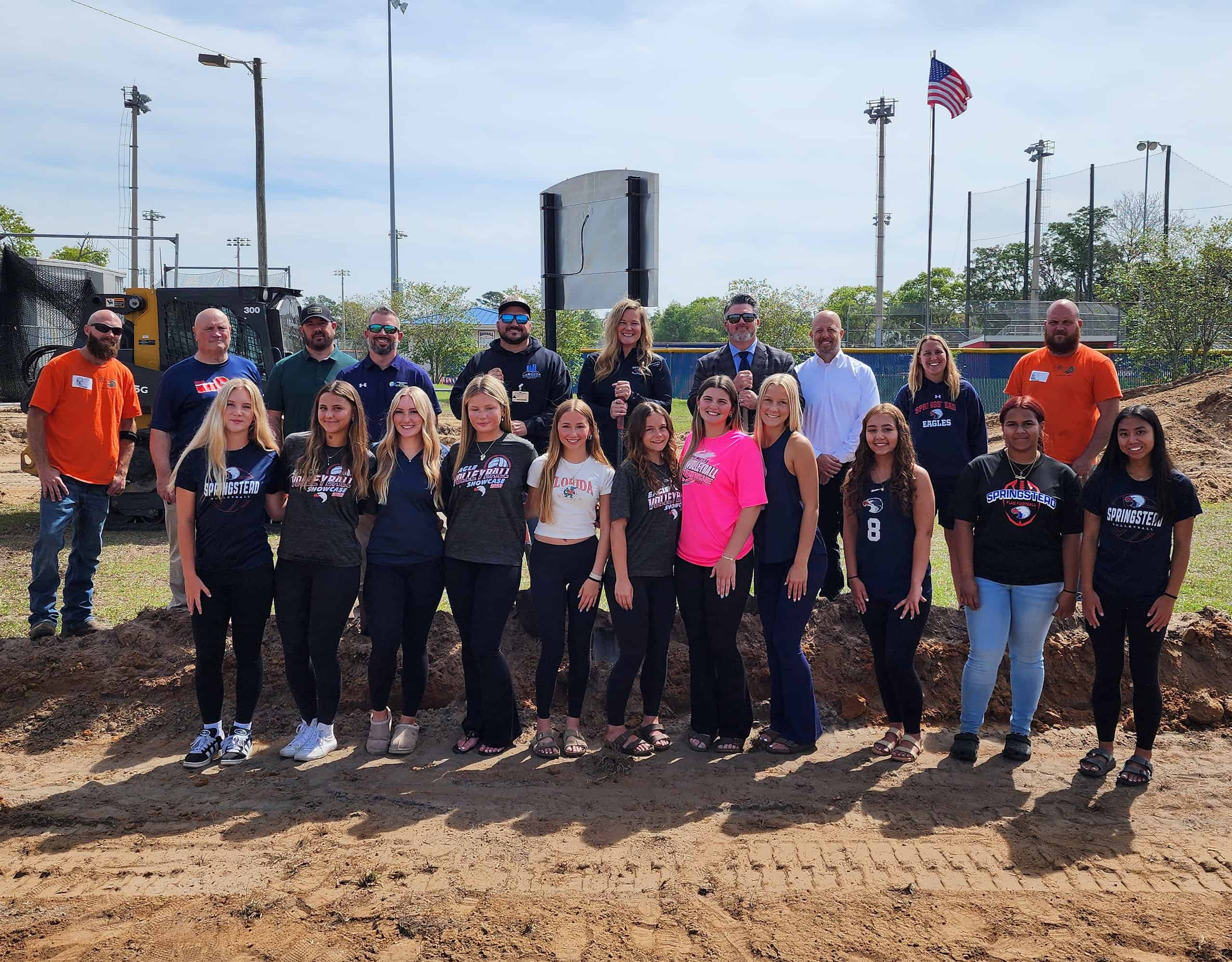 (From left to right with shovels) District Athletic Director Dustin Kupcik, Contractor Danny LaRocca, Coach Andrea Gracey, and Attorney Chris Chambers break ground on Springstead's beach volleyball courts with the team, coaches, dignitaries, and crew members on Tuesday. [Photo by Austyn Szempruch]