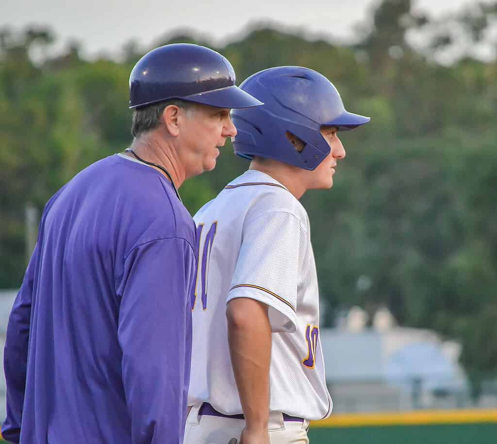 Hernando head coach Tim Sims speaks to Nino Urso at third base during Thursday's regional quarterfinal game at Emerson Field. [Credit: Chris Bernhardt Jr.]