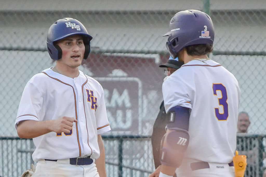 Hernando's Nino Urso celebrates with Palmer Looper, 3, after scoring on a balk against North Marion on Thursday night. [Credit: Chris Bernhardt Jr.]