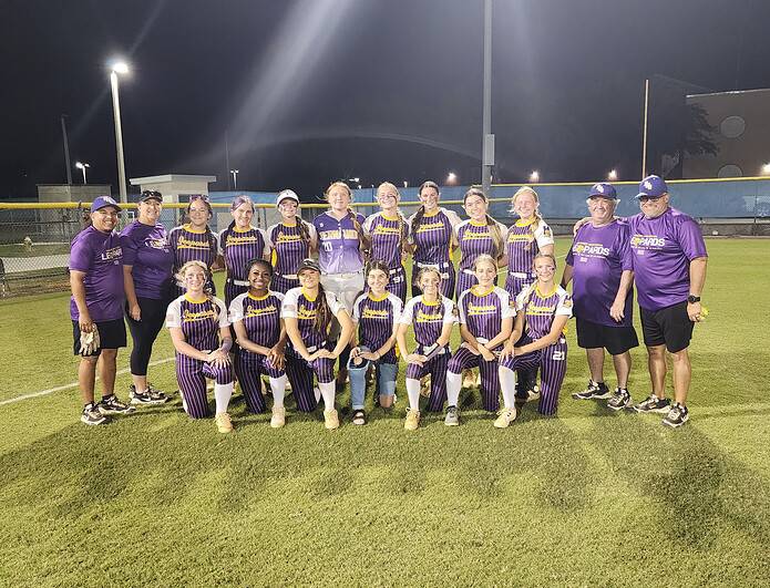Leopards Softball Head Coach (far right) and, 20, Junior LeAnna Clark (center left) stand for a team photo after the Leopards' 8-4 district semifinal victory. [Photo by Austyn Szempruch]