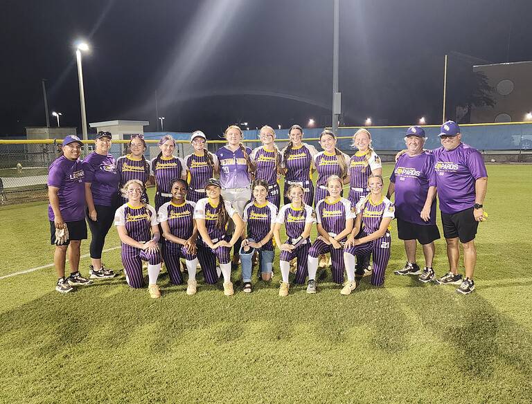 Leopards Softball Head Coach (far right) and, 20, Junior LeAnna Clark (center left) stand for a team photo after the Leopards' 8-4 district semifinal victory. [Photo by Austyn Szempruch]